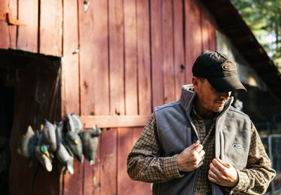 Man wearing MST Solid Windproof Layering Vest with stand-up collar, zippered chest pocket, and hand warmer pockets, showcasing its windproof, lightweight design.