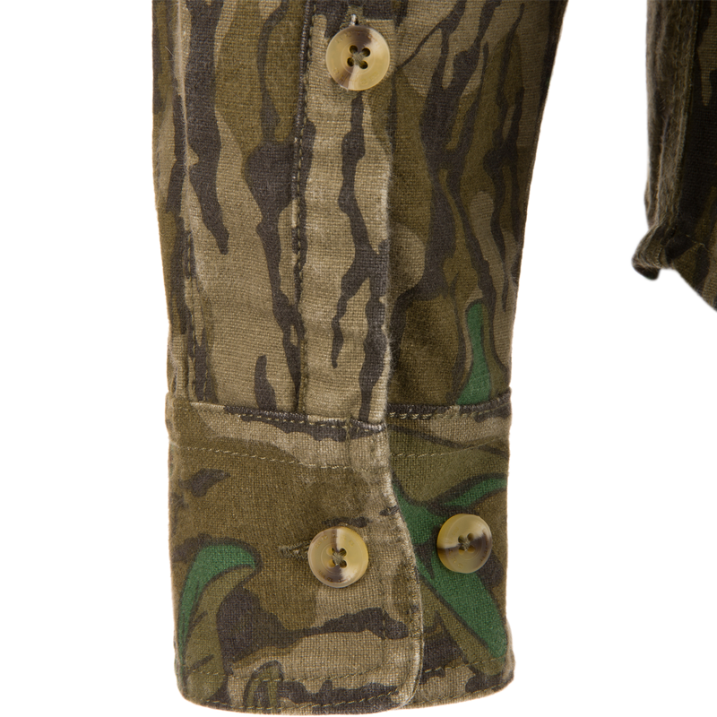 Close-up of the Throwback 80 Button Down Field Shirt, showcasing its camouflage fabric, durable triple-needle stitching, and reinforced buttons, ideal for outdoor adventures.