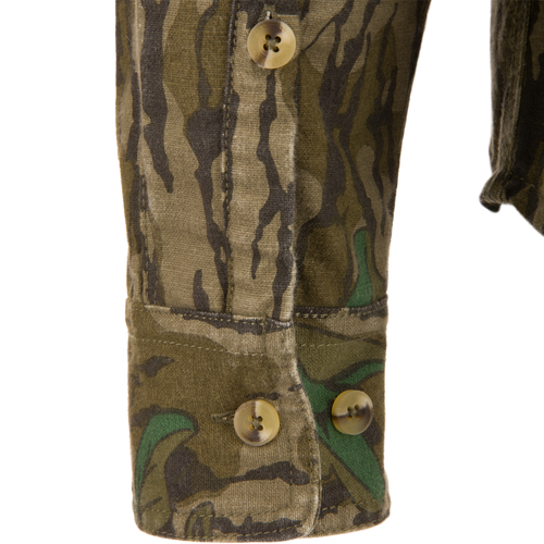 Close-up of the Throwback 80 Button Down Field Shirt, showcasing its camouflage fabric, durable triple-needle stitching, and reinforced buttons, ideal for outdoor adventures.
