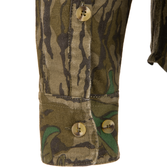 Close-up of the Throwback 80 Button Down Field Shirt, showcasing its camouflage fabric, durable triple-needle stitching, and reinforced buttons, ideal for outdoor adventures.