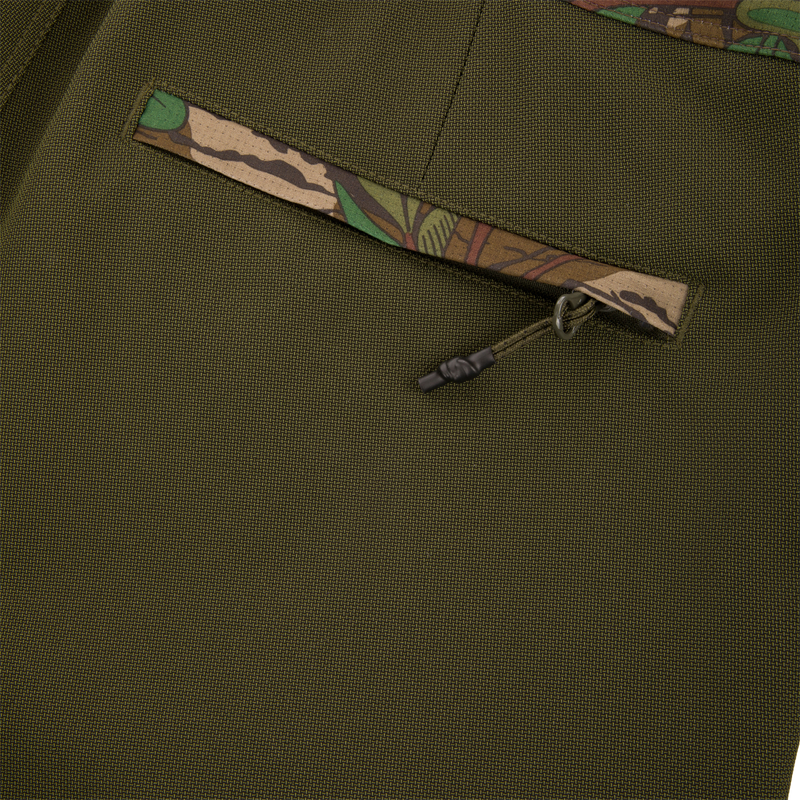 Turkey Bib with Spider Web Technology featuring close-up of durable zipper and fabric, showcasing breathable, water-resistant polyester ideal for hunting adventure.