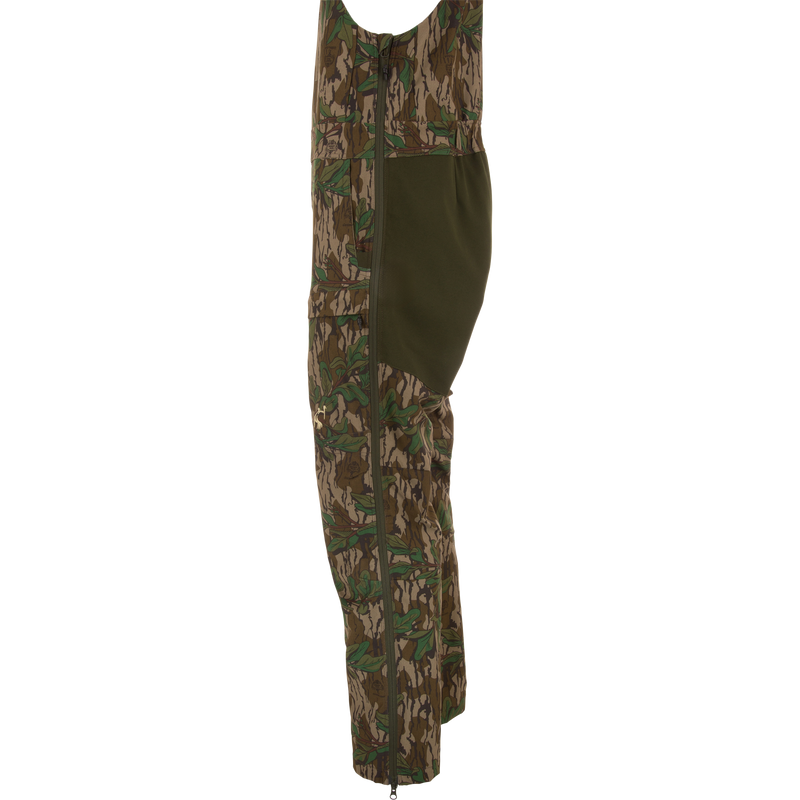 Turkey Bib with Spider Web Technology, featuring camouflage design, zippered sides, and cargo pockets, offers durability and mobility for hunting enthusiasts.