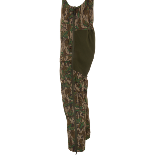 Turkey Bib with Spider Web Technology, featuring camouflage design, zippered sides, and cargo pockets, offers durability and mobility for hunting enthusiasts.