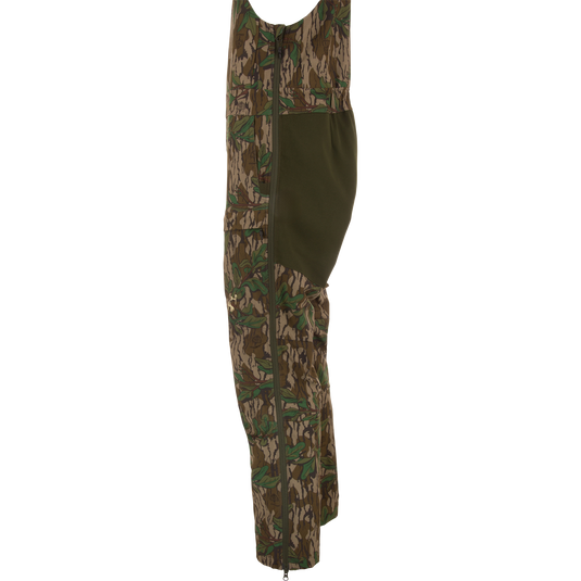 Turkey Bib with Spider Web Technology, featuring camouflage design, zippered sides, and cargo pockets, offers durability and mobility for hunting enthusiasts.