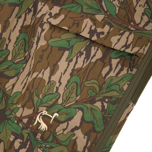 Close-up of a camouflage pocket on the Turkey Bib with Spider Web Technology, highlighting breathable, durable fabric with functional storage for hunting essentials.