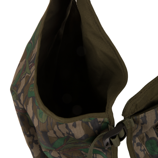 Youth Time and Motion Turkey Vest: Camouflage design with zipper, black buckle, and neoprene straps; includes quick-draw slate call pouch and removable padded seat cushion for hunting.