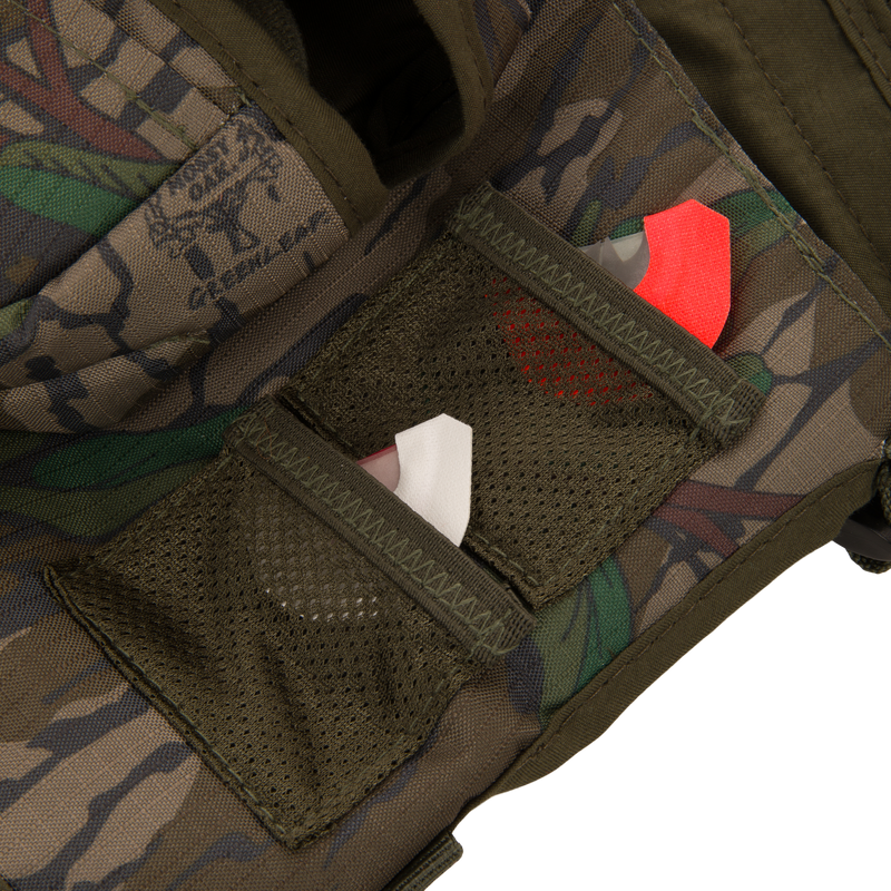 Youth Time and Motion Turkey Vest close-up, highlighting durable 300 denier rip-stop fabric with visible pocket and red tag detail for hunting utility.