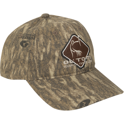 Camo Cotton Ol' Tom Diamond Logo Cap with earth-tone camo, structured six-panel design, and stylized turkey emblem, ideal for hunting. Mid-profile fit, adjustable closure.