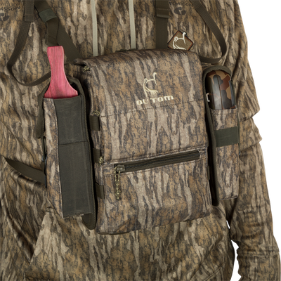 Turkey Chest Pack with camouflage design, featuring multiple compartments, detachable bino harness, and accessories, perfect for hunting trips.