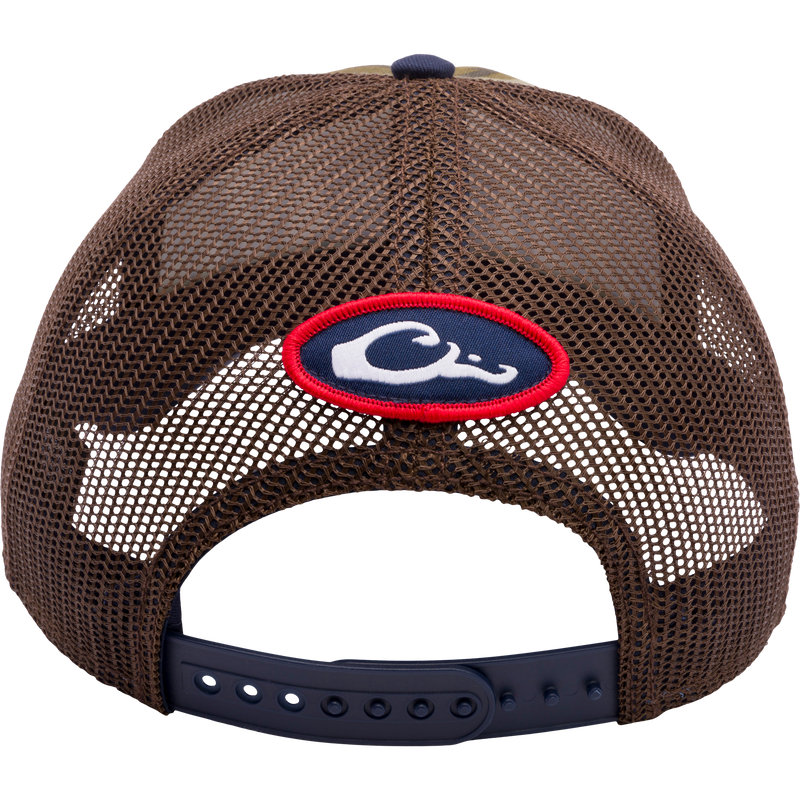 A Ole Miss Bottomland Mesh Back Cap by Drake Waterfowl, featuring Mossy Oak Bottomland Camo pattern, structured crown, mesh panels, X-Peak visor, and 3D embroidered college logo.
