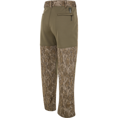 Back view of olive wind-resistant Spoonie Hollywood Pant hunting pants featuring camouflage print on the lower legs and a zippered back pocket.