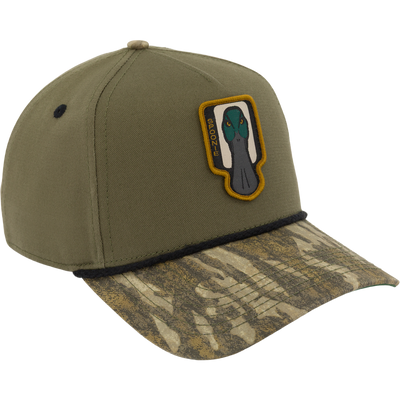 Mossy Oak Bottomland Spoonie Logo Cap with a camouflage-patterned brim, featuring a mallard duck head patch and the word SPOONIE embroidered on the front.