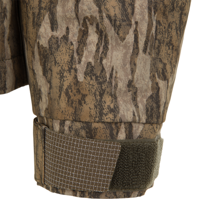 Close-up of a Spoonie Shoveler Insulated Jacket sleeve featuring a camouflage pattern and an adjustable hook-and-loop cuff tab.