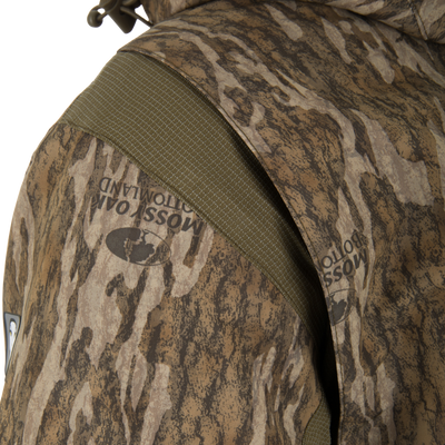 Close-up of a Spoonie Shoveler Insulated Jacket featuring a vertical olive green panel on the shoulder.