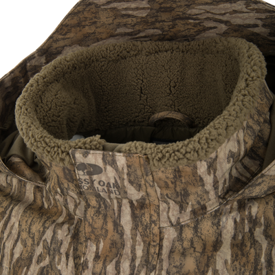Spoonie Shoveler Insulated Jacket featuring a waterproof camouflage print and a fleece-lined collar.