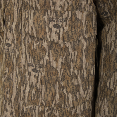 Close-up of a brown and tan Mossy Oak Bottomland camouflage Spoonie Shoveler Insulated Jacket featuring a chest pocket.