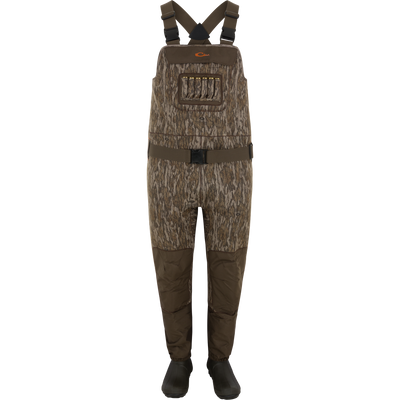 Spoonie Mud-Sucker Neoprene Waders in Mossy Oak Bottomland camo, featuring dark brown reinforced knees, a waist belt, and built-in chest shell loops.