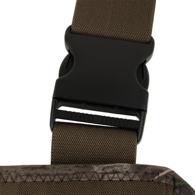 Close-up of a black plastic side-release buckle on an olive green strap attached to the camouflage neoprene material of a Spoonie Mud-Sucker Neoprene Wader.
