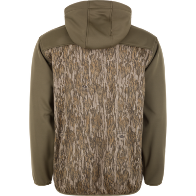 Back view of the Spoonie Hollywood Jacket, a wind-resistant softshell hunting jacket featuring olive green sleeves and a wood-patterned camouflage back panel.