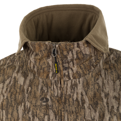 Close-up of a Spoonie Waterproof Fleece Lined Quarter Zip Jacket in camouflage with a tan collar and a zipper pull labeled Spoonie.