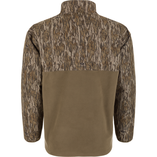Back view of a Spoonie Eqwader Quarter Zip, featuring a tree-bark camouflage pattern on the upper portion and solid olive green fabric on the lower torso.