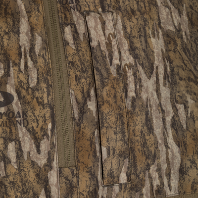 Spoonie Eqwader Quarter Zip waterfowl hunting jacket in a brown and tan camouflage pattern, featuring a quarter-zip pullover design with a vertical chest pocket.