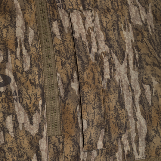 Spoonie Eqwader Quarter Zip waterfowl hunting jacket in a brown and tan camouflage pattern, featuring a quarter-zip pullover design with a vertical chest pocket.