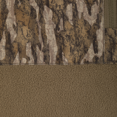 Close-up of a Spoonie Eqwader Quarter Zip featuring a top section with a brown camouflage print and a bottom section of solid brown fleece, separated by a horizontal seam.