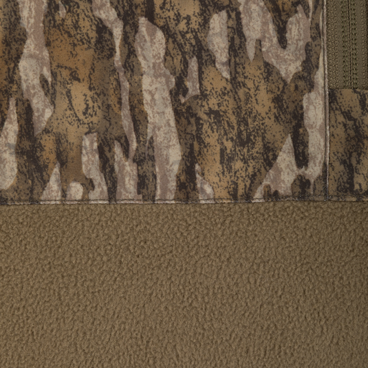Close-up of a Spoonie Eqwader Quarter Zip featuring a top section with a brown camouflage print and a bottom section of solid brown fleece, separated by a horizontal seam.