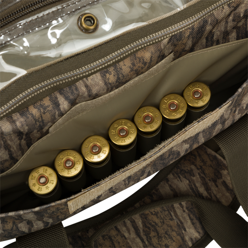 Large Blind Bag with cartridges, gold object, and bullet casings. Waterproof, durable, and organized with 18 pockets. Perfect for hunting gear and accessories.