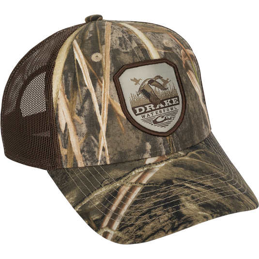 A vintage duck shield patch on a classic trucker mesh-back cap with the Drake logo, a go-to part of your outfit for any occasion.