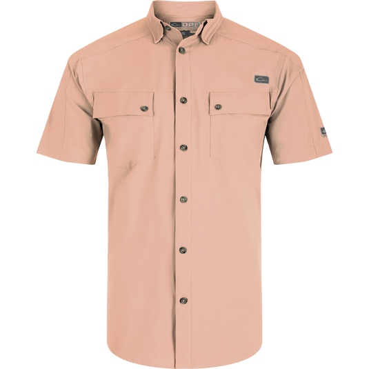 A close-up of the Performance Mesh Paneled Short Sleeve Shirt, featuring a hidden button-down collar, laser-punched mesh back panels for ventilation, and two button-through flap chest pockets. The shirt is made of a luxurious blend of nylon and spandex, offering stretch, drape, and high performance. It also provides UPF 50 sun protection, moisture-wicking, and quick-drying properties. Ideal for outdoor activities like hunting, fishing, and more.
