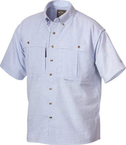 A youth seersucker shirt with blue and white stripes, featuring a collar, button-down front, and a Magnattach chest pocket. Made of breathable StayCool fabric with front and back heat vents. Perfect for hunting and outdoor activities.