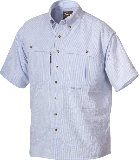 A youth seersucker shirt with blue and white stripes, featuring a collar, button-down front, and a Magnattach chest pocket. Made of breathable StayCool fabric with front and back heat vents. Perfect for hunting and outdoor activities.