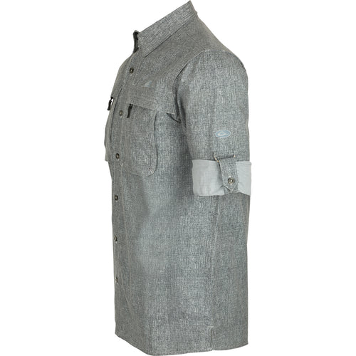 Heritage Heather Shirt L/S: A performance shirt made of 100% polyester micro mesh. Features include UPF30 sun protection, moisture-wicking, and quick-drying fabric. Classic styling with a hidden button-down collar, vented cape back, and two front chest pockets. Perfect for outdoor activities or the office.