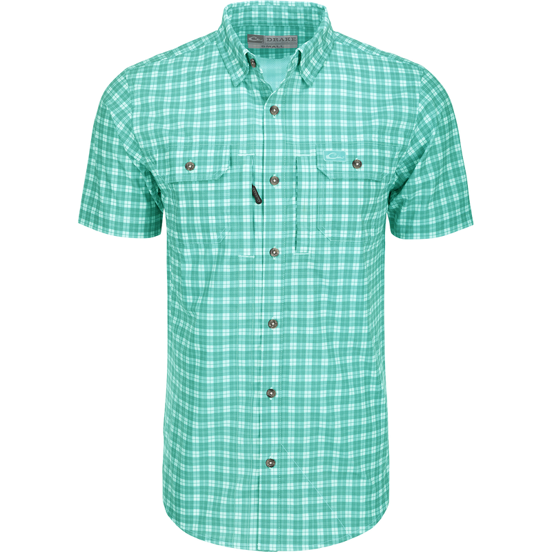 A close-up of the Drake Hunter Creek Check Plaid Shirt S/S, featuring a hidden button-down collar, vented back cape, and two button-through chest pockets with a zipper pocket. Lightweight and moisture-wicking, with UPF30 sun protection and built-in stretch.