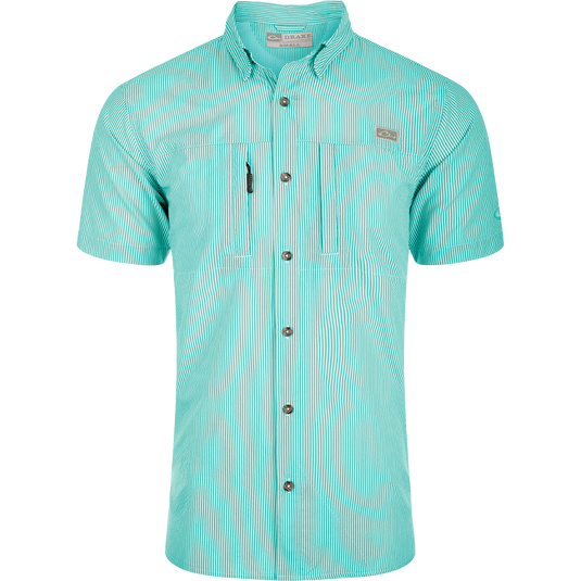 Classic Seersucker Stripe Shirt S/S: A close-up of a soft, featherweight shirt with a seersucker texture. Features include UPF 30 sun protection, moisture-wicking, and a button-down collar. It has a hidden zippered right chest pocket and a left chest pocket with a Magnattach™ closure. The vented cape back provides additional ventilation, and the split tail hem allows for versatile styling. The image shows the shirt's pattern and fabric.