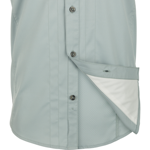 Close-up of Wingshooter Trey Solid Dobby Shirt S/S with hidden collar, chest pockets, and vented back, made of performance fabric for outdoor activities.