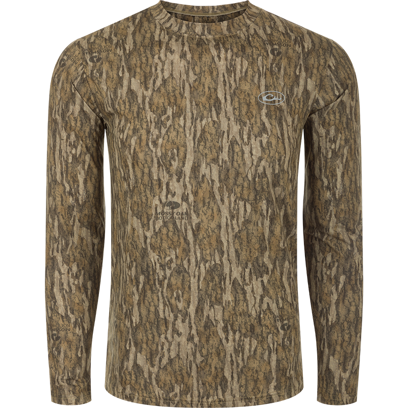 A long sleeved shirt with a tree pattern, designed for optimum comfort and durability. Made of 92% Polyester/8% Spandex with 4-Way Stretch for flexibility. Features Shield 4 Sun™ UPF 50+, Shield 4 Coolant™, Shield 4 Odor™, and Shield 4 Stains™ treatments for sun protection, heat resistance, odor control, and stain resistance. From Drake Waterfowl, a store specializing in high-quality hunting gear and clothing.