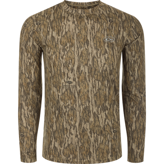 A long sleeved shirt with a tree pattern, designed for optimum comfort and durability. Made of 92% Polyester/8% Spandex with 4-Way Stretch for flexibility. Features Shield 4 Sun™ UPF 50+, Shield 4 Coolant™, Shield 4 Odor™, and Shield 4 Stains™ treatments for sun protection, heat resistance, odor control, and stain resistance. From Drake Waterfowl, a store specializing in high-quality hunting gear and clothing.