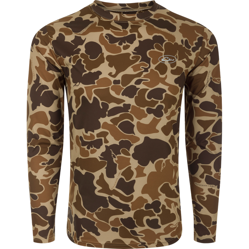 A long-sleeved shirt with a camouflage pattern, designed for optimum comfort and durability. Made with 92% Polyester/8% Spandex and 4-Way Stretch for superior flexibility and protection. Features Shield 4 Sun™ UPF 50+, Shield 4 Coolant™, Shield 4 Odor™, and Shield 4 Stains™ treatments for effective sun, heat, odor, and stain protection. Perfect for big game hunting, waterfowl hunting, turkey hunting, and fishing.