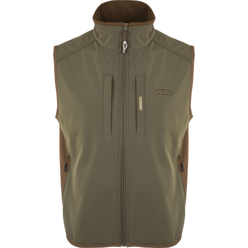 EST Windproof Tech Vest, featuring a logo and zipper details. This khaki vest is made of high-quality polyester tech shell and bonded fleece lining with a windproof membrane. It's perfect for outdoor activities and can be worn as a core or outer layer. Stay warm and stylish with this versatile vest from Drake Waterfowl.