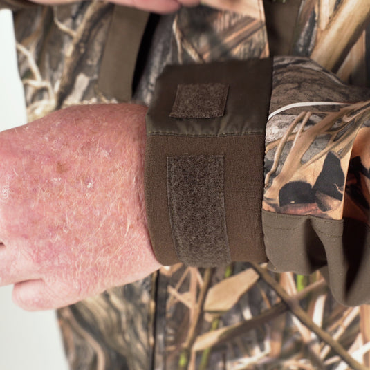 A close-up of a person's arm wearing the EST Heat-Escape Full Zip 2.0, showcasing the Heat-Escape vents under the arms for ventilation.