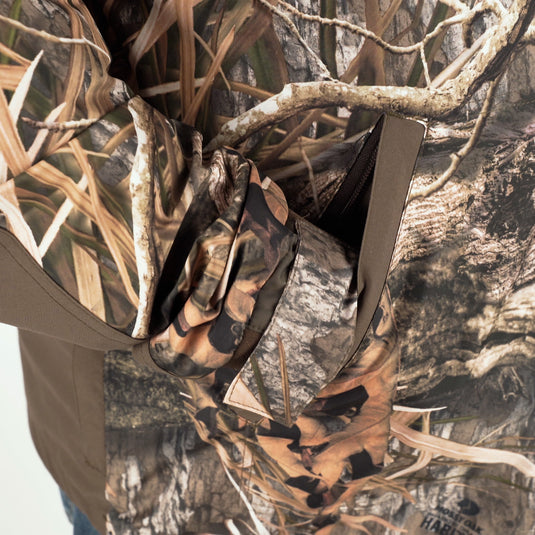 A person wearing the EST Heat-Escape Full Zip 2.0, a camouflage shirt, in an outdoor setting.
